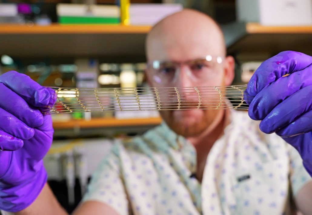 Professor Jason Burdick demonstrates the elasticity of the new 3D-printed material